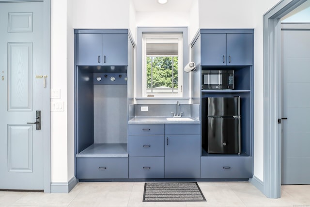 13 Kellogg St, Brookfield, CT 06804 - mudroom featuring a sink and light tile patterned flooring