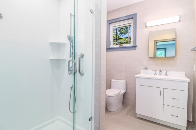13 Kellogg St, Brookfield, CT 06804 - bathroom featuring a stall shower, tile walls, vanity, toilet, and tile patterned flooring