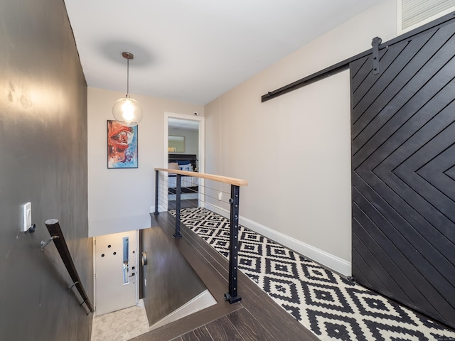 hallway featuring an upstairs landing and baseboards