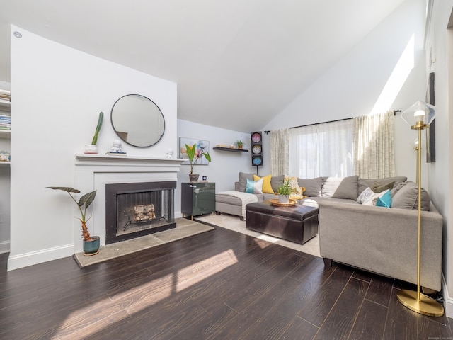 living room featuring a fireplace, vaulted ceiling, baseboards, and wood finished floors