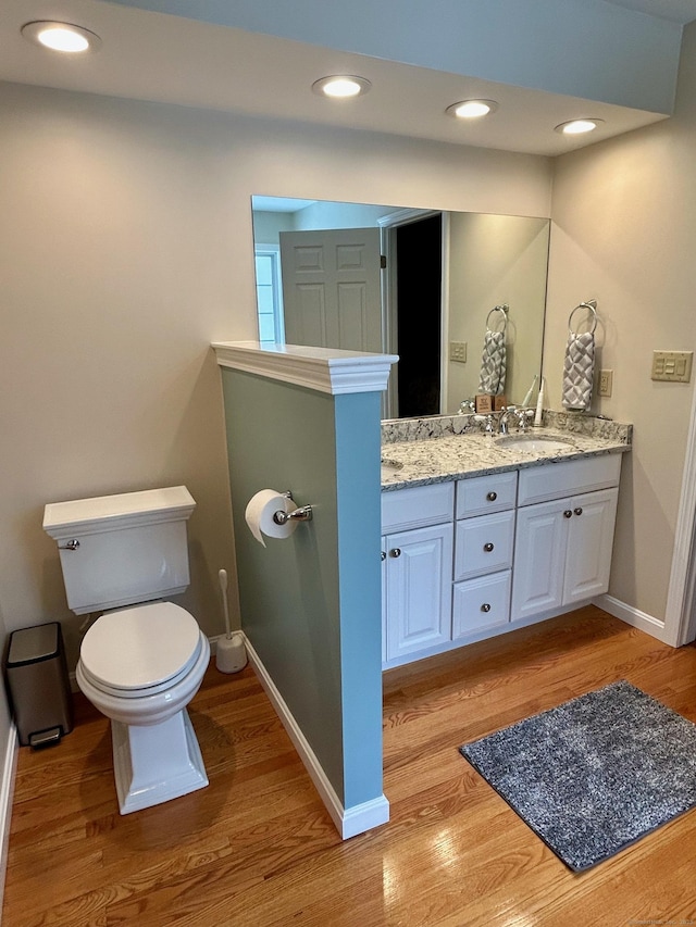 92 Sherwood Ln, Norwich, CT 06360 - bathroom featuring toilet, baseboards, double vanity, wood finished floors, and recessed lighting