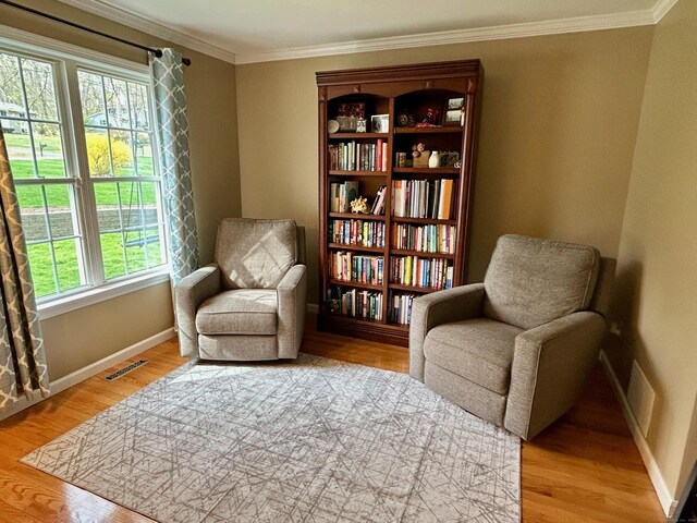 92 Sherwood Ln, Norwich, CT 06360 - sitting room featuring healthy amount of natural light, crown molding, baseboards, and light wood-style flooring