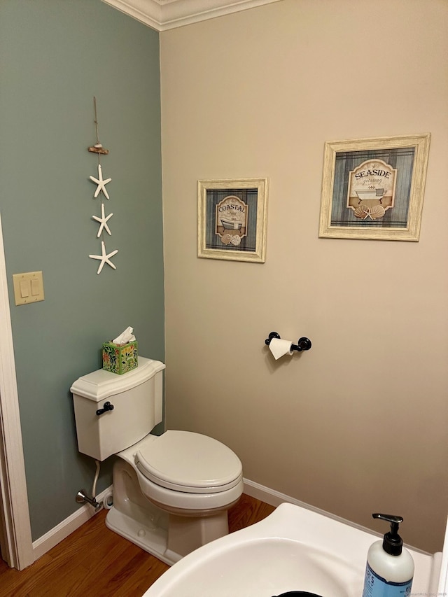 92 Sherwood Ln, Norwich, CT 06360 - bathroom with baseboards, toilet, wood finished floors, and ornamental molding