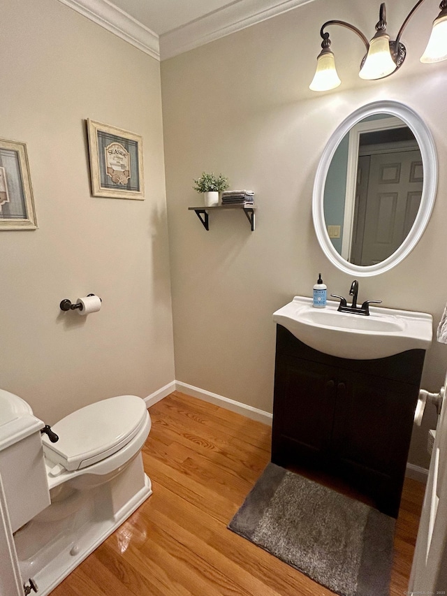 92 Sherwood Ln, Norwich, CT 06360 - half bathroom with toilet, vanity, wood finished floors, crown molding, and baseboards