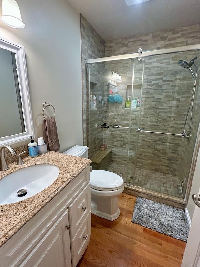 92 Sherwood Ln, Norwich, CT 06360 - full bathroom with toilet, vanity, wood finished floors, and a shower stall