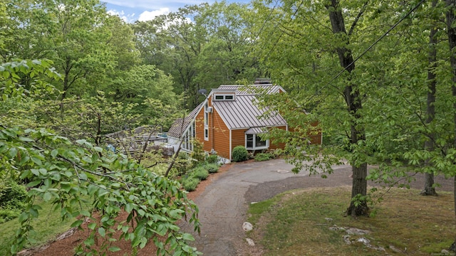27 Whippoorwill Ln, Bethany, CT 06524 - view of side of home featuring a standing seam roof, driveway, metal roof, and a wooded view