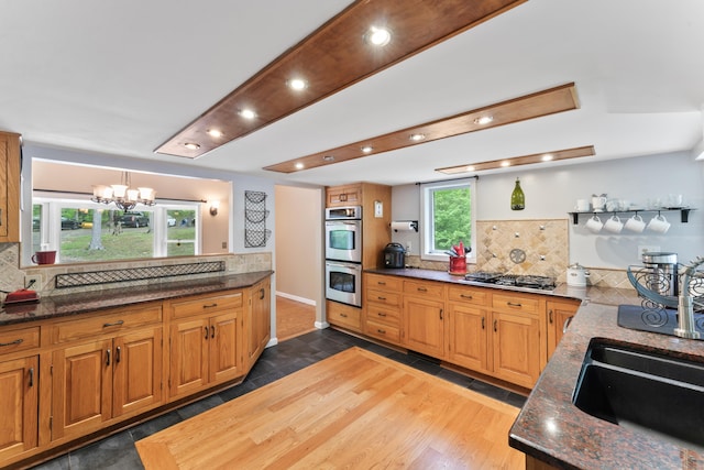 27 Whippoorwill Ln, Bethany, CT 06524 - kitchen featuring appliances with stainless steel finishes, tasteful backsplash, a chandelier, recessed lighting, and a sink