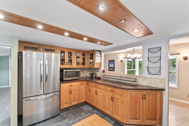 27 Whippoorwill Ln, Bethany, CT 06524 - kitchen featuring appliances with stainless steel finishes, backsplash, glass insert cabinets, a chandelier, and recessed lighting