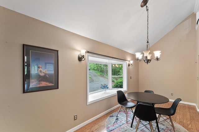 27 Whippoorwill Ln, Bethany, CT 06524 - dining space featuring lofted ceiling, wood finished floors, baseboards, and a chandelier