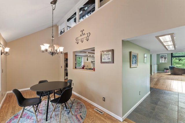27 Whippoorwill Ln, Bethany, CT 06524 - dining area with baseboards, a chandelier, and a towering ceiling