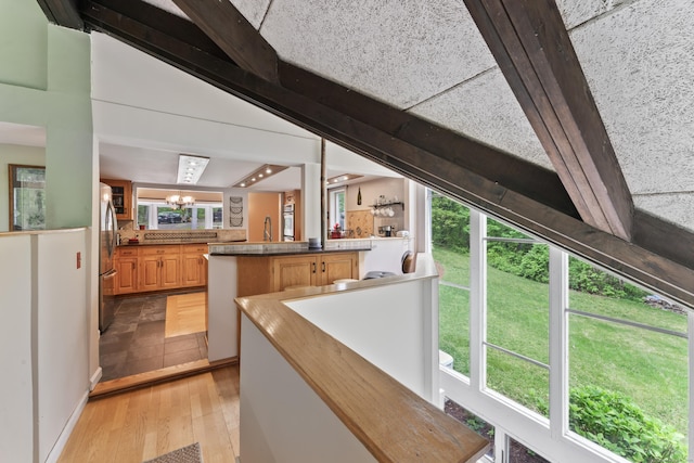 27 Whippoorwill Ln, Bethany, CT 06524 - bar with light wood-style floors, healthy amount of natural light, freestanding refrigerator, and a chandelier