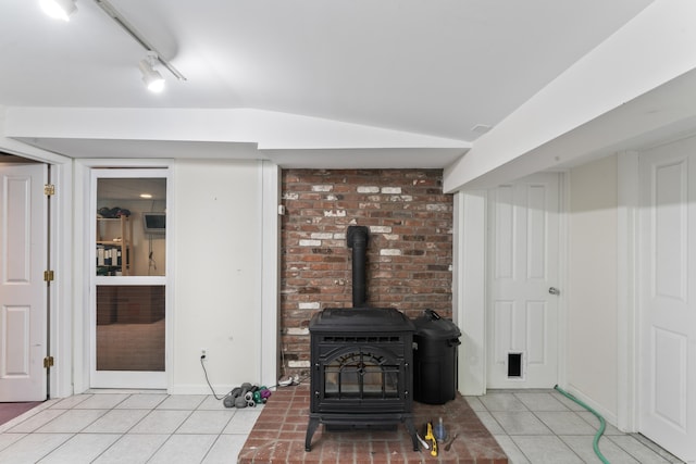 27 Whippoorwill Ln, Bethany, CT 06524 - living room with light tile patterned floors, a wood stove, track lighting, and baseboards