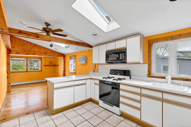 49 Hartford Ave, Old Saybrook, CT 06475 - kitchen featuring gas stove, black microwave, a sink, a peninsula, and a baseboard heating unit