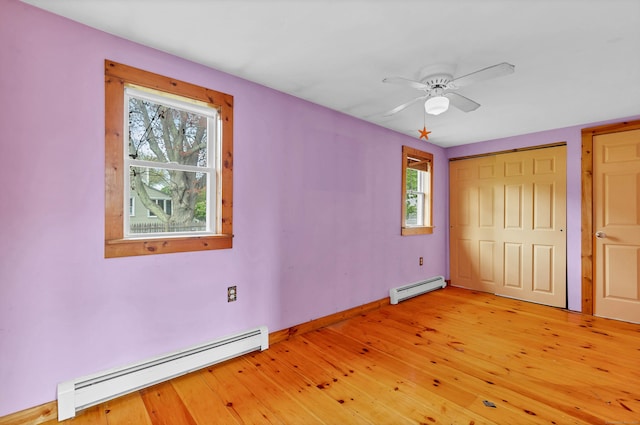 49 Hartford Ave, Old Saybrook, CT 06475 - unfurnished bedroom featuring baseboard heating, light wood finished floors, baseboards, and a ceiling fan