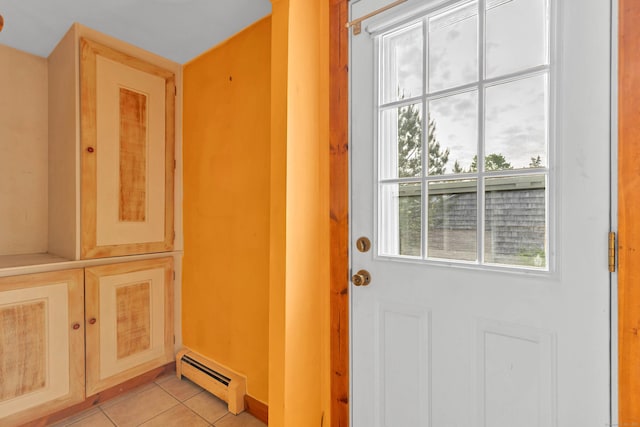 49 Hartford Ave, Old Saybrook, CT 06475 - doorway to outside with a baseboard radiator and light tile patterned flooring