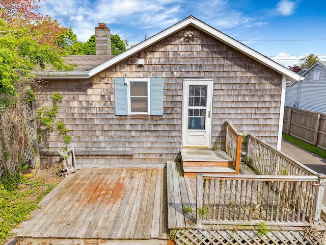 49 Hartford Ave, Old Saybrook, CT 06475 - rear view of house with a chimney and a wooden deck