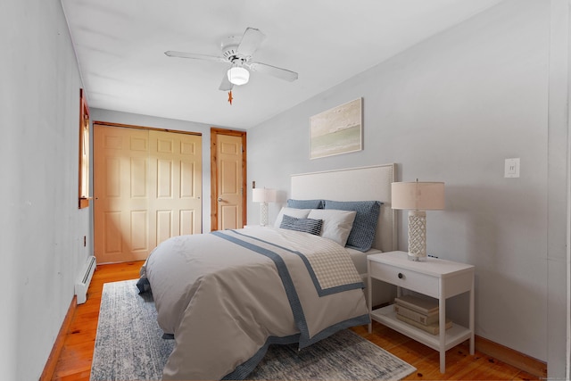 49 Hartford Ave, Old Saybrook, CT 06475 - bedroom with a baseboard heating unit, light wood finished floors, a closet, and baseboards