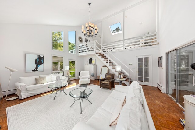 10 Twin Falls Ln, Westport, CT 06880 - living area featuring a baseboard radiator, stairs, a towering ceiling, a chandelier, and plenty of natural light