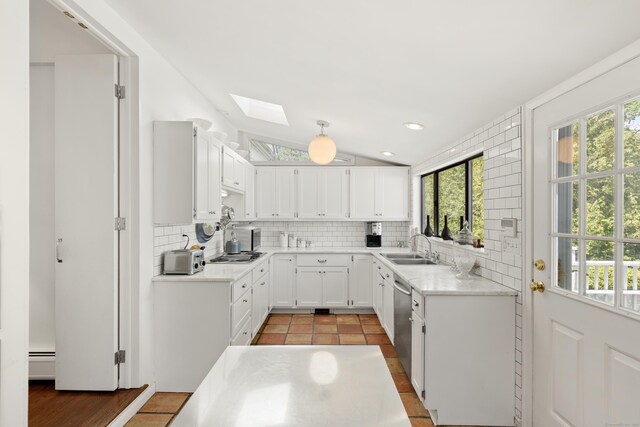 10 Twin Falls Ln, Westport, CT 06880 - kitchen featuring a skylight, decorative backsplash, a sink, white cabinetry, and light countertops