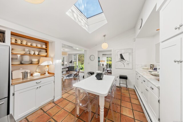 10 Twin Falls Ln, Westport, CT 06880 - kitchen with open shelves, a skylight, white cabinetry, baseboard heating, and lofted ceiling