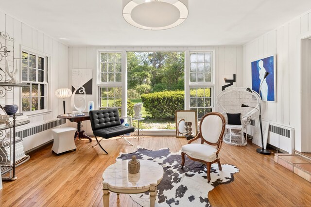 10 Twin Falls Ln, Westport, CT 06880 - sitting room featuring radiator, light wood-style floors, plenty of natural light, and a decorative wall