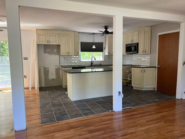 132 Walkley Dr, Southington, CT 06489 - kitchen with ceiling fan, cream cabinets, dark wood-style floors, and a sink