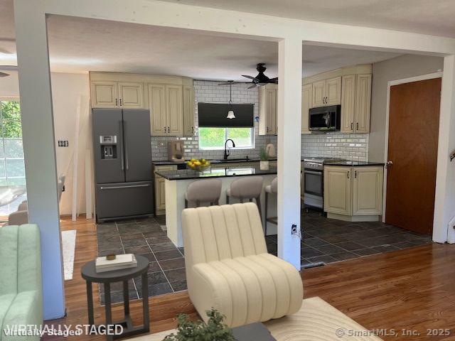 132 Walkley Dr, Southington, CT 06489 - kitchen with black appliances, cream cabinetry, ceiling fan, a sink, and dark countertops