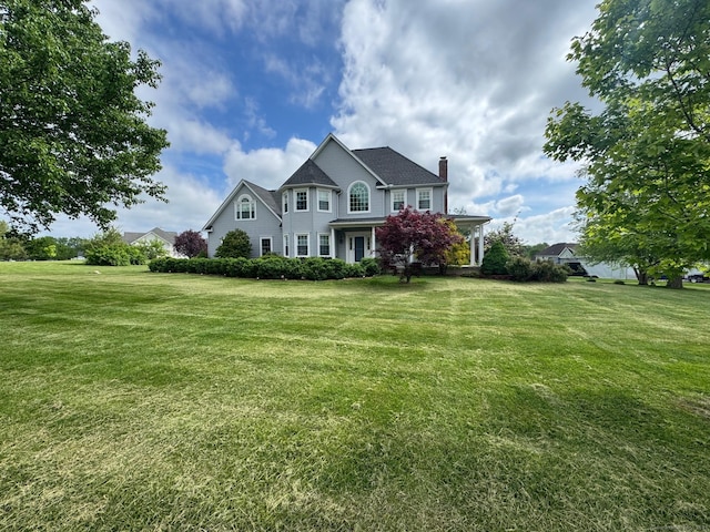 39 Farmstead Ln, Suffield, CT 06078 - view of front facade featuring a front lawn and a chimney