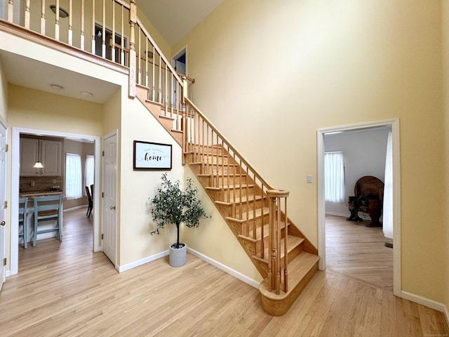 39 Farmstead Ln, Suffield, CT 06078 - stairs featuring a high ceiling, wood finished floors, and baseboards