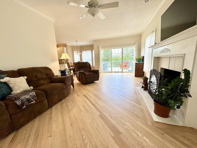 39 Farmstead Ln, Suffield, CT 06078 - living room with ornamental molding, light wood-style flooring, a ceiling fan, and a tile fireplace