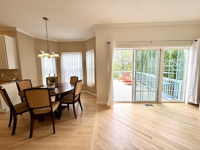 39 Farmstead Ln, Suffield, CT 06078 - dining space featuring a chandelier, light wood-type flooring, baseboards, and ornamental molding