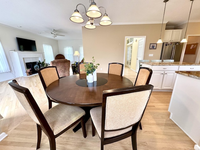 39 Farmstead Ln, Suffield, CT 06078 - dining room with a ceiling fan, a fireplace, light wood-style floors, crown molding, and a chandelier