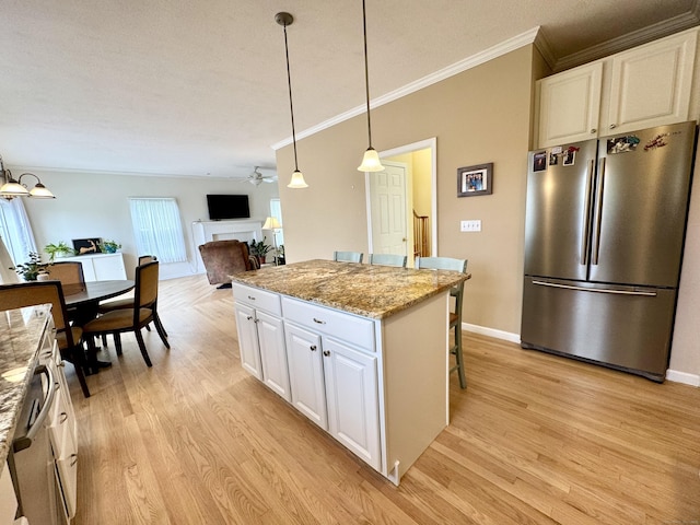 39 Farmstead Ln, Suffield, CT 06078 - kitchen with freestanding refrigerator, ornamental molding, a center island, light wood-type flooring, and a kitchen breakfast bar