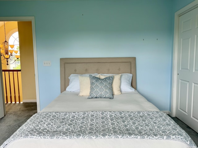 39 Farmstead Ln, Suffield, CT 06078 - bedroom with dark carpet and a chandelier