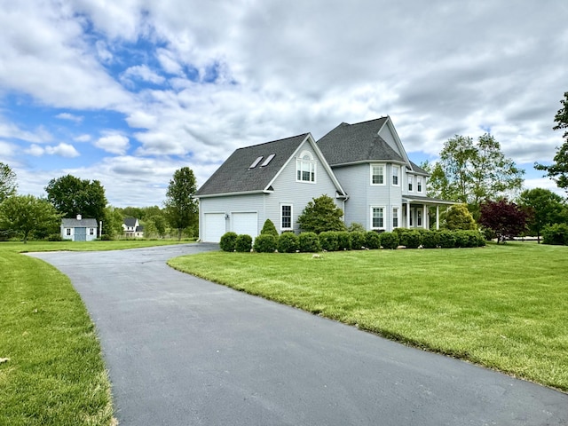 39 Farmstead Ln, Suffield, CT 06078 - view of side of home featuring driveway, a garage, and a yard