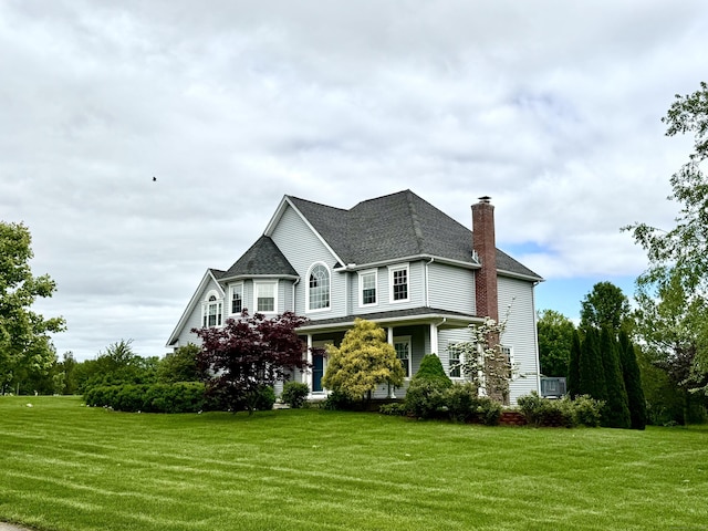 39 Farmstead Ln, Suffield, CT 06078 - view of front of house featuring a chimney, a front lawn, and roof with shingles