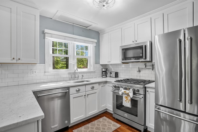 12 Woody Pl, Ridgefield, CT 06877 - kitchen with high end appliances, white cabinets, decorative backsplash, and dark wood finished floors