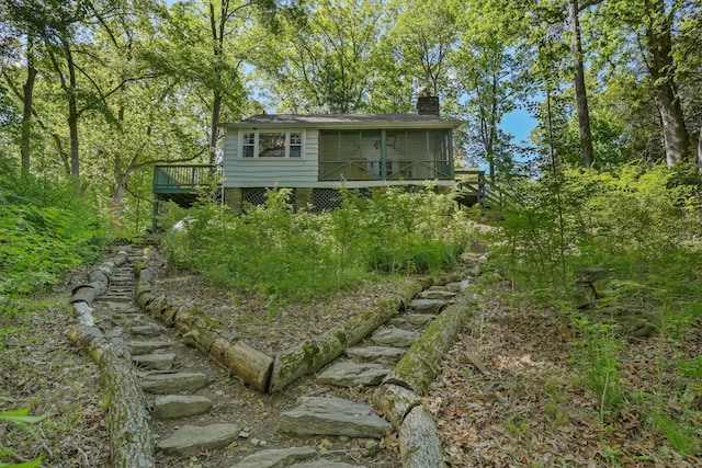 12 Woody Pl, Ridgefield, CT 06877 - back of property featuring a sunroom, a deck, and a chimney