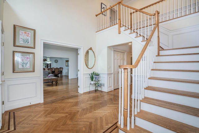 7 Brighton Ln, Simsbury, CT 06070 - interior space with a wainscoted wall, a decorative wall, and a high ceiling