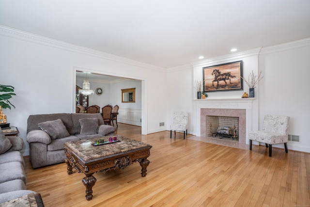 7 Brighton Ln, Simsbury, CT 06070 - living area with crown molding, a high end fireplace, visible vents, and wood finished floors