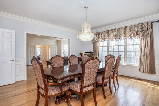 7 Brighton Ln, Simsbury, CT 06070 - dining area with a chandelier, light wood-style flooring, a healthy amount of sunlight, and ornamental molding