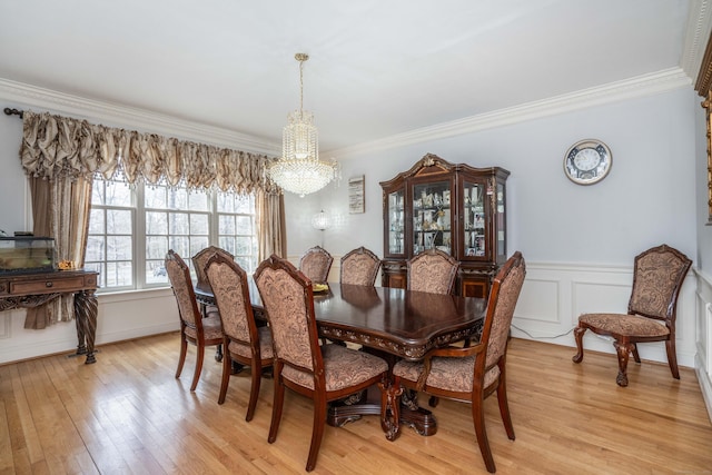 7 Brighton Ln, Simsbury, CT 06070 - dining space with an inviting chandelier, ornamental molding, a wainscoted wall, and light wood finished floors
