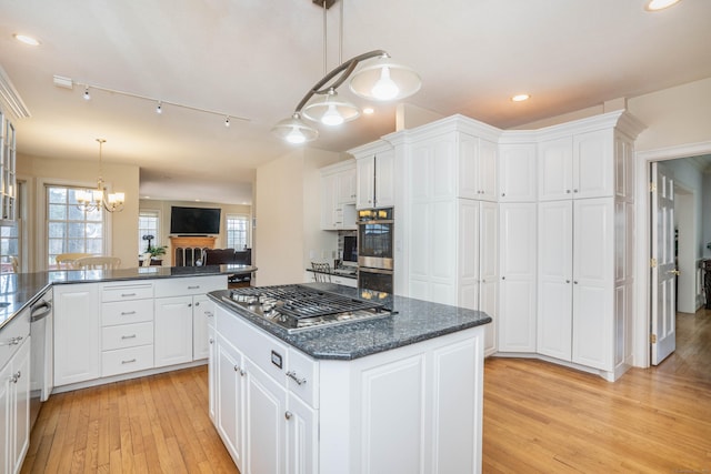7 Brighton Ln, Simsbury, CT 06070 - kitchen featuring a kitchen island, light wood-style flooring, appliances with stainless steel finishes, and white cabinets