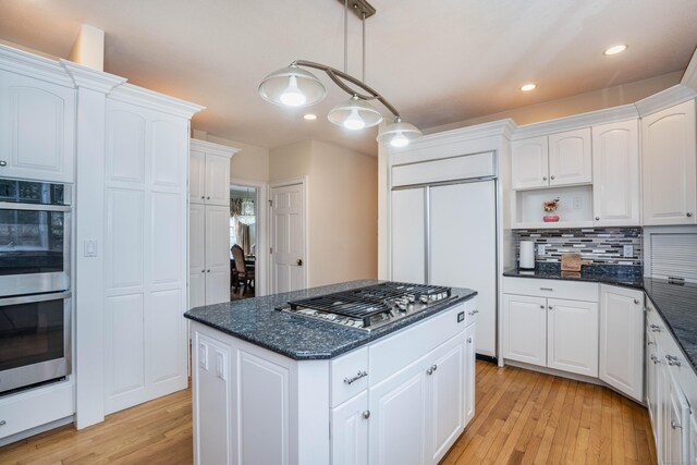 7 Brighton Ln, Simsbury, CT 06070 - kitchen featuring light wood finished floors, white cabinets, appliances with stainless steel finishes, and decorative backsplash
