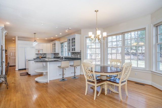 7 Brighton Ln, Simsbury, CT 06070 - dining space with a wealth of natural light, light wood-style flooring, and visible vents