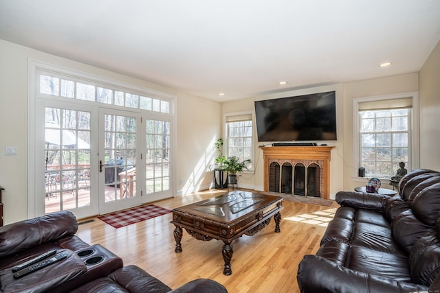 7 Brighton Ln, Simsbury, CT 06070 - living room with plenty of natural light, wood finished floors, a brick fireplace, and recessed lighting