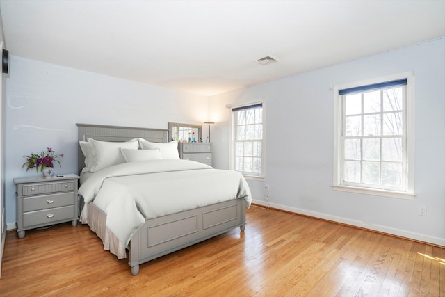7 Brighton Ln, Simsbury, CT 06070 - bedroom with visible vents, light wood-style flooring, and baseboards