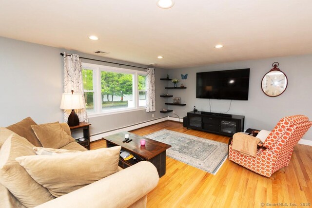 86 Rustic Ln, East Hartford, CT 06118 - living area featuring baseboard heating, wood finished floors, and recessed lighting