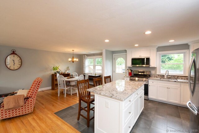 86 Rustic Ln, East Hartford, CT 06118 - kitchen featuring stainless steel appliances, a sink, plenty of natural light, white cabinetry, and recessed lighting