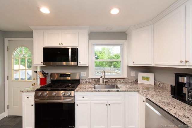 86 Rustic Ln, East Hartford, CT 06118 - kitchen featuring appliances with stainless steel finishes, a sink, white cabinetry, light stone countertops, and recessed lighting